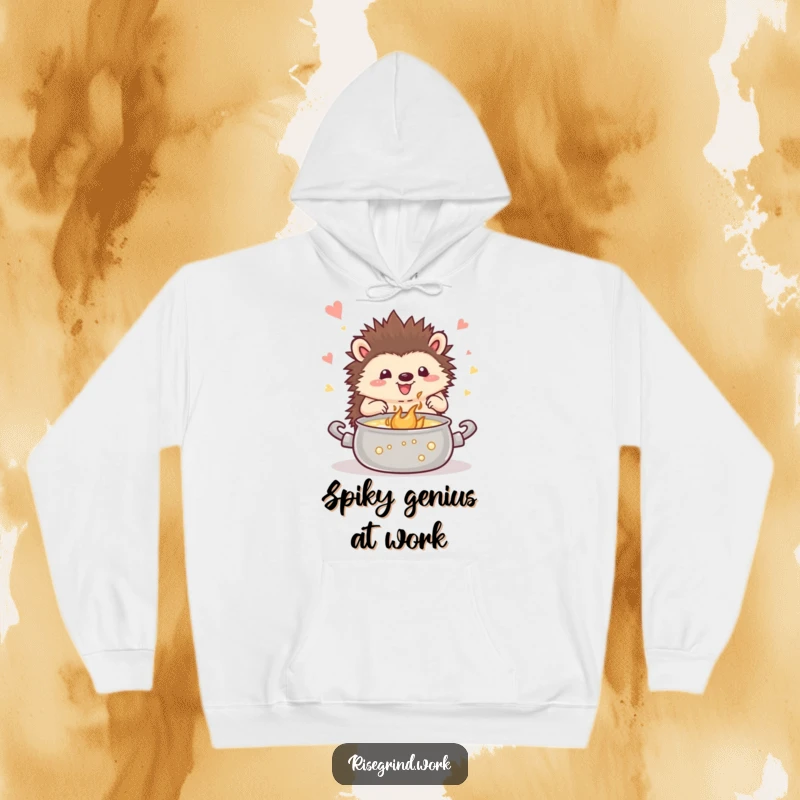 Funny hedgehog hoodie, depicting a happy hedgehog stirring a pot of bubbling inspiration, ideal for creative comfort.