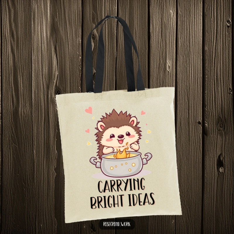 Funny hedgehog tote bag, showing a happy hedgehog stirring a pot of inspiration, great for carrying creative supplies.